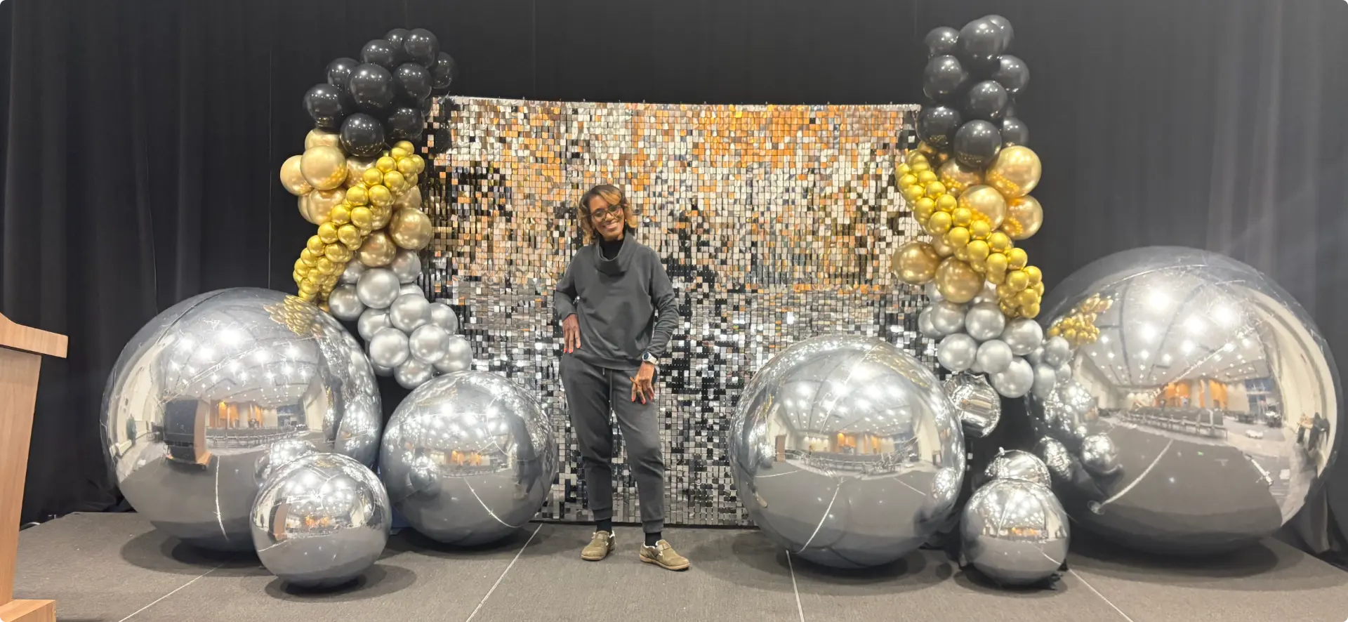 Silver sequin wall framed by balloon towers and chrome spheres — Balloon Décor by Good Time Mascots in Columbus, Ohio