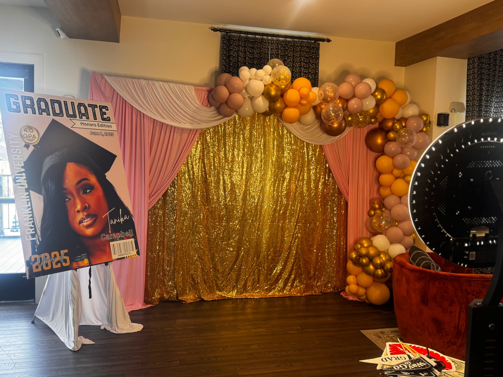 Personalized graduate magazine-cover poster set beside a sequin and balloon backdrop — Custom Graphics & Signage by Good Time Mascots in Columbus, Ohio
