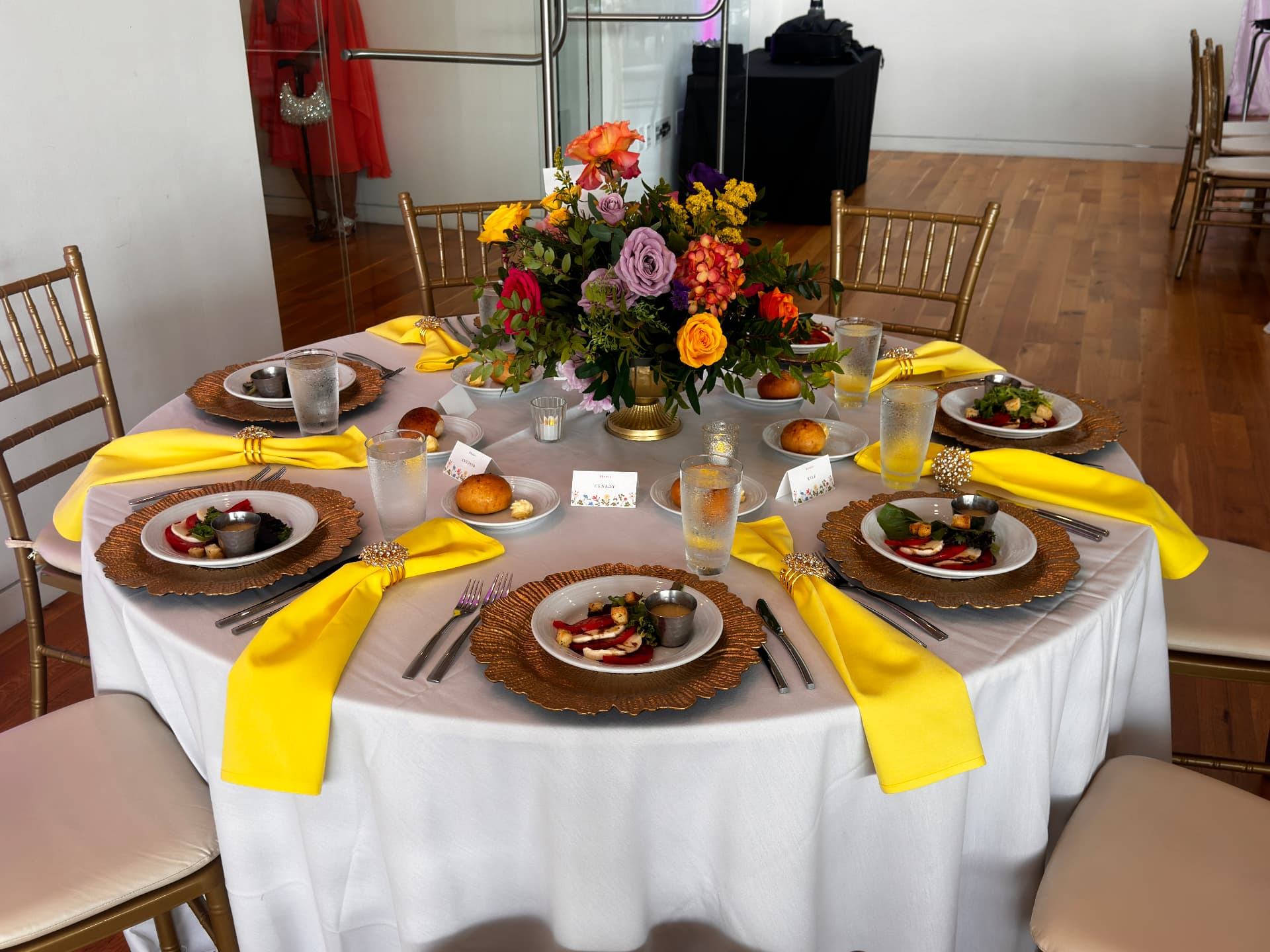 Gold chargers and crystal napkin rings at a placed setting — Tablescape & Culinary Presentation by Good Time Mascots in Columbus, Ohio