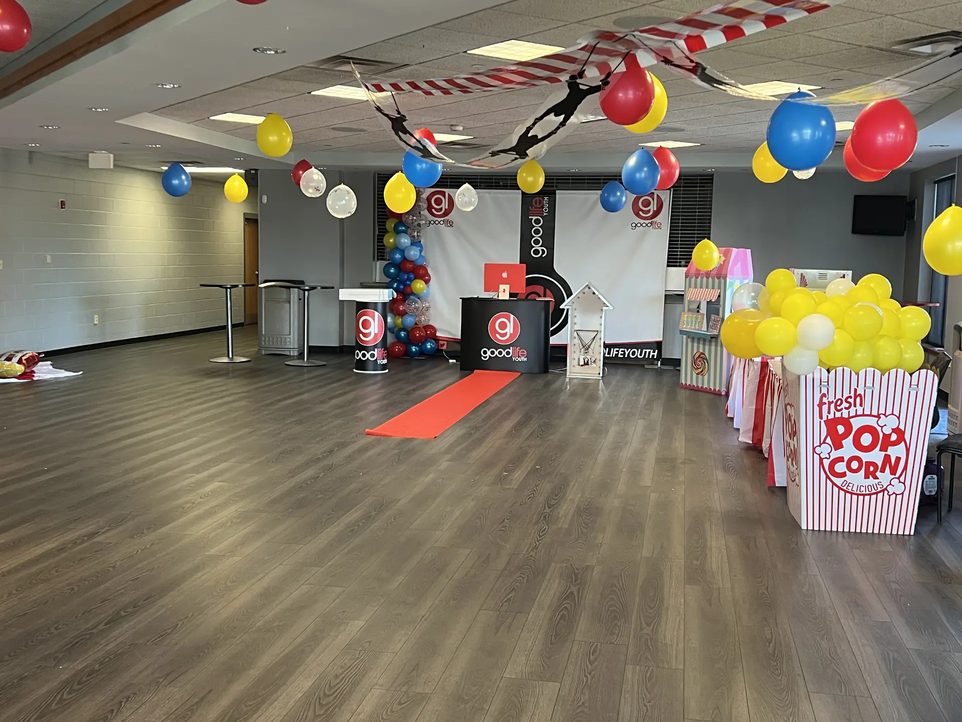 Carnival-themed youth stage with balloon columns and a branded backdrop — Church & Community Events by Good Time Mascots in Columbus, Ohio
