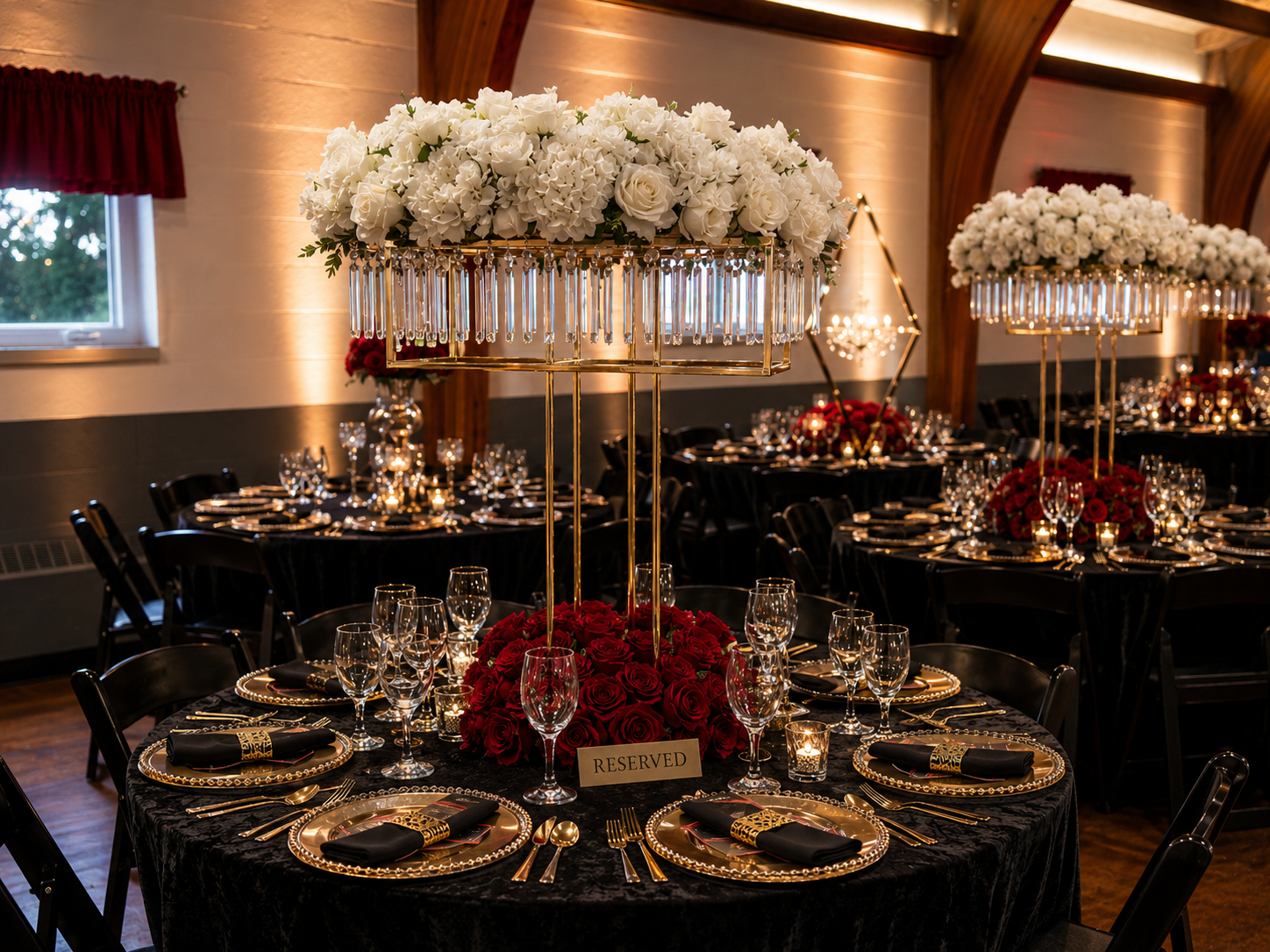 Black-and-gold tablescape with crystal-draped floral towers — Weddings by Good Time Mascots in Columbus, Ohio