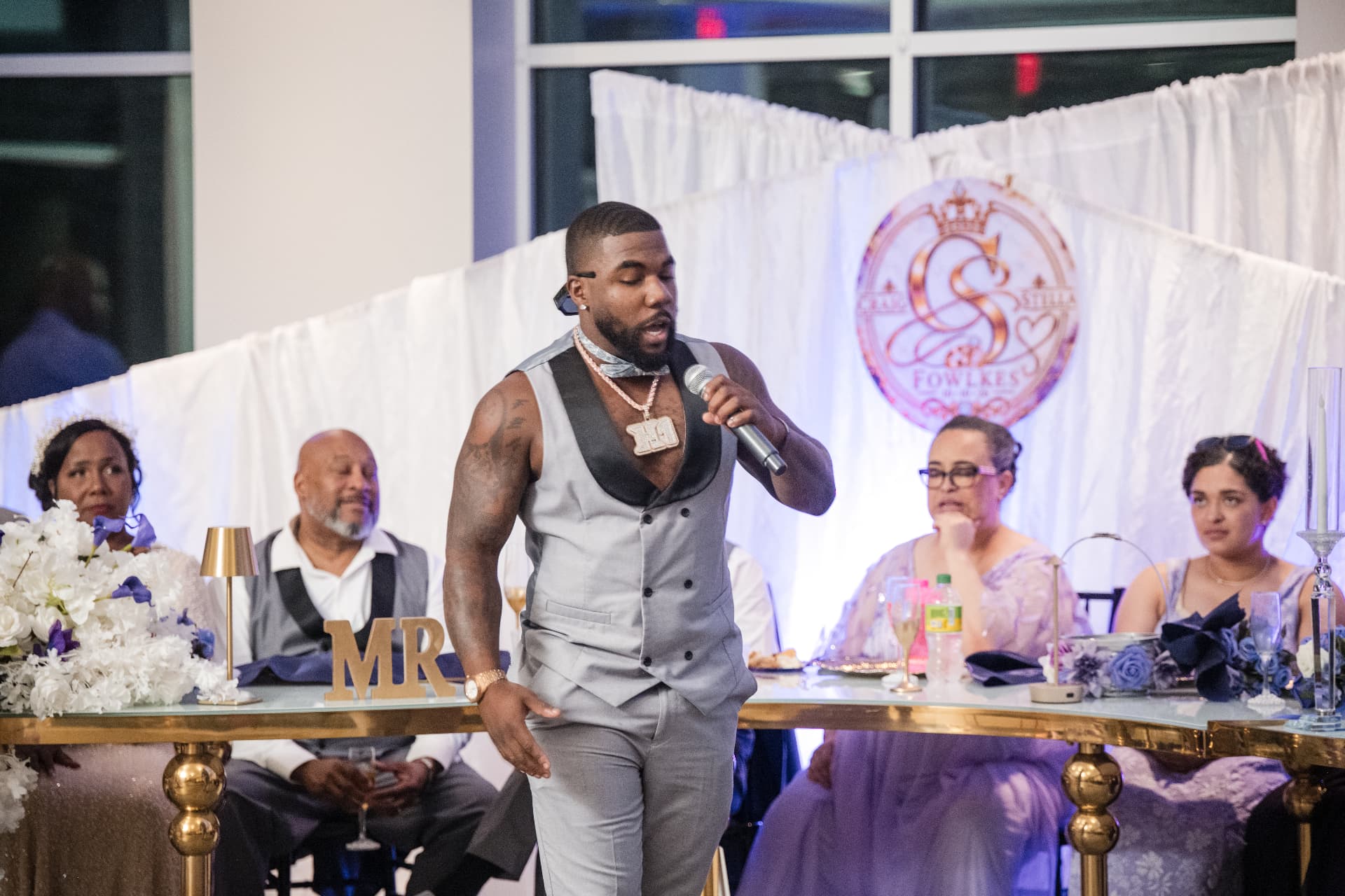 Head table and pleated drape backdrop printed with the couple's custom monogram — Custom Graphics & Signage by Good Time Mascots in Columbus, Ohio