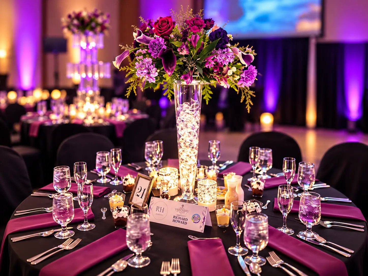 Fairy-lit trumpet vase with calla lilies and roses above a black-linen gala table — Corporate & Brand Experiences by Good Time Mascots in Columbus, Ohio