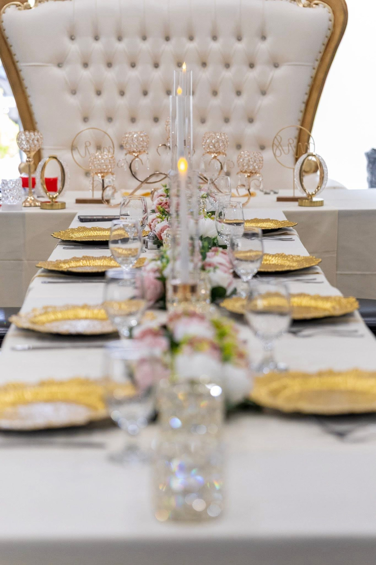 Sweetheart table with a blush floral garland and gold-trimmed chair — Weddings by Good Time Mascots in Columbus, Ohio