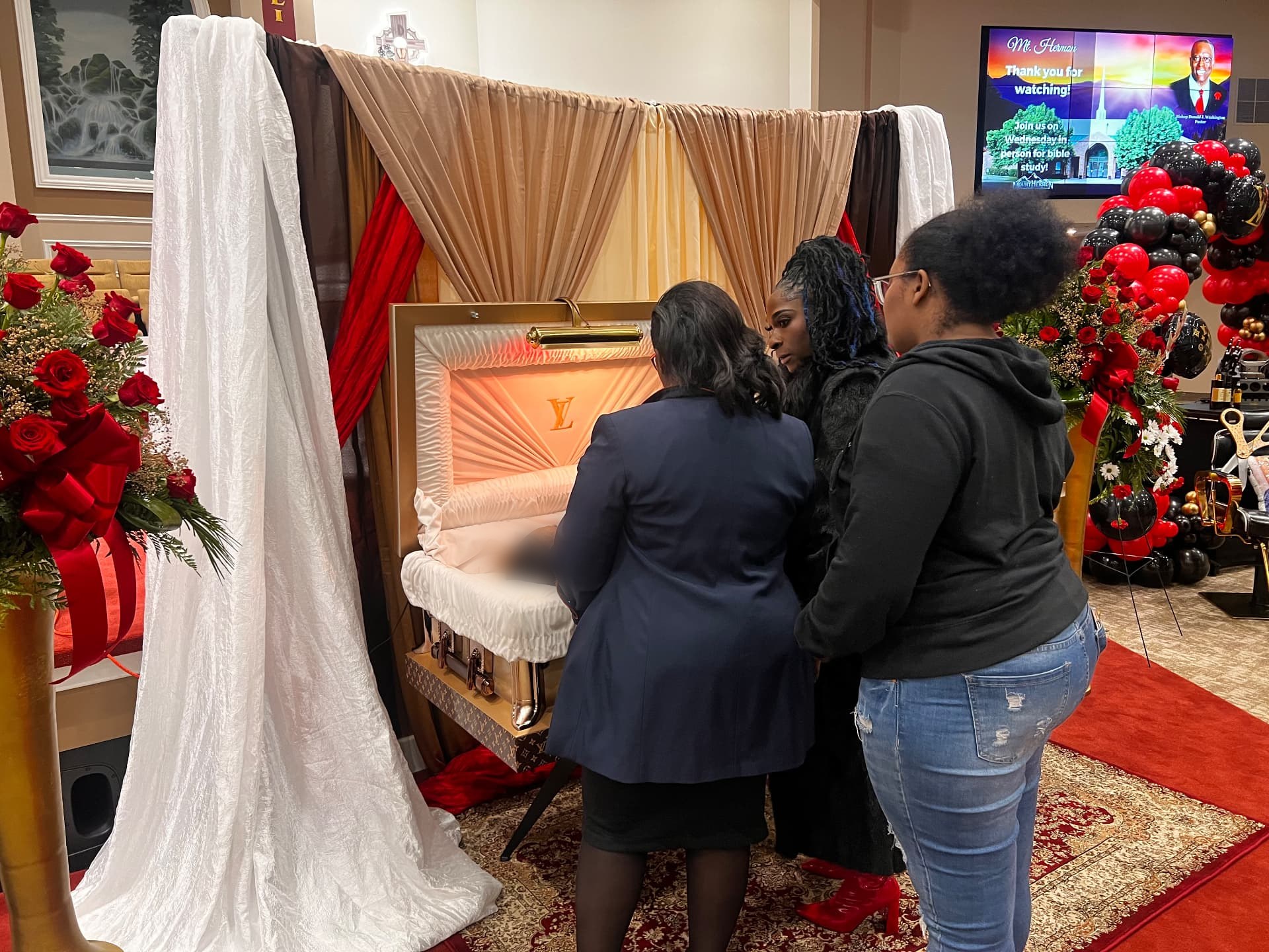 Family moment beside the draped tribute canopy — Celebration of Life & Memorials by Good Time Mascots in Columbus, Ohio