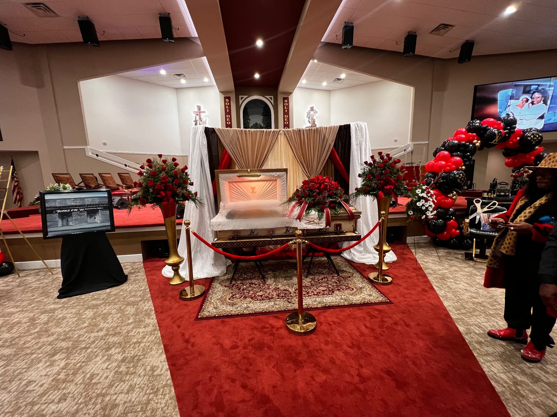 Red, gold and ivory tribute setting with draped canopy, roses and stanchions — Celebration of Life & Memorials by Good Time Mascots in Columbus, Ohio