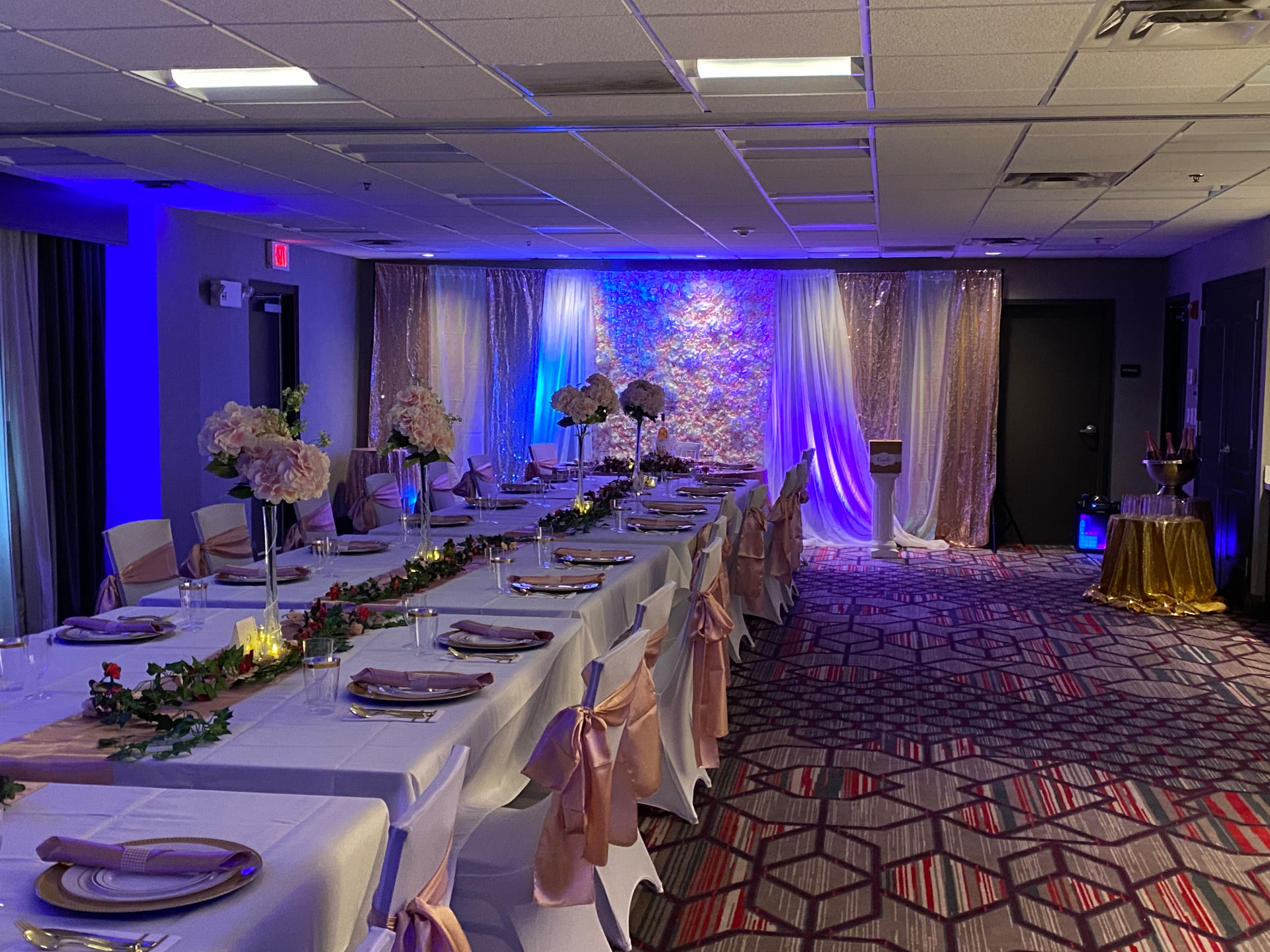 Blush and ivory banquet with an uplit floral backdrop and lectern — Church & Community Events by Good Time Mascots in Columbus, Ohio